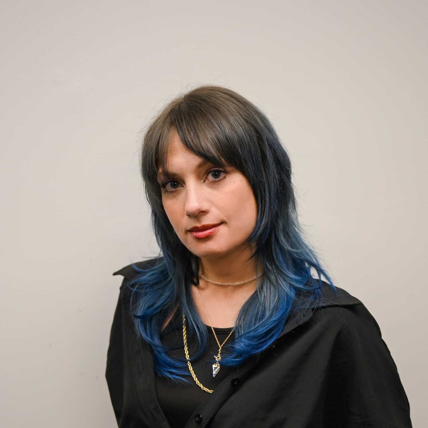 Portrait of Marlyn Kostelac, a professional stylist at Snoballs Salon, showcasing their expertise and style.