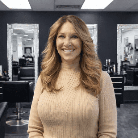 Portrait of Nina Stobaugh, a professional stylist at Snoballs Salon, showcasing their expertise and style.