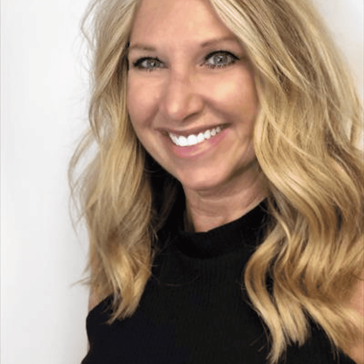 Portrait of Nina Stobaugh, a professional stylist at Snoballs Salon, showcasing their expertise and style.